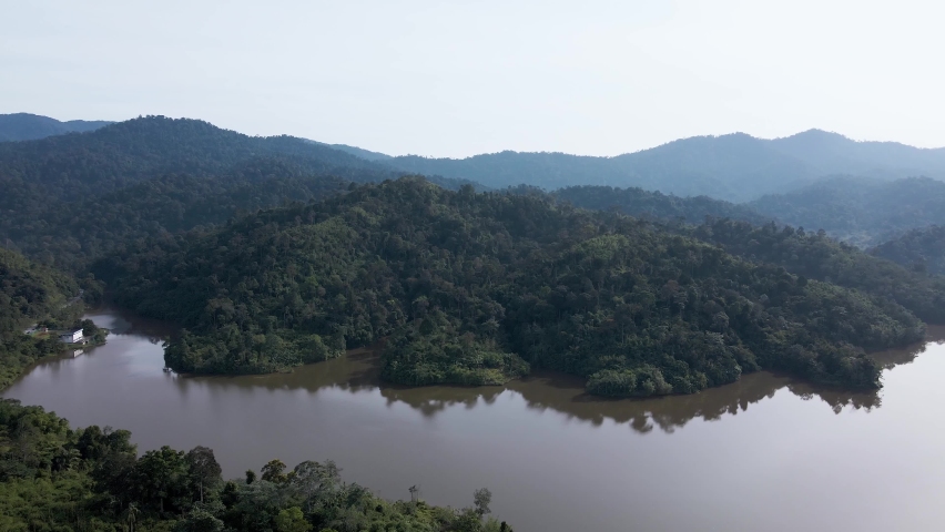 Aerial view at mountain lakeside with camera pan right in morning, Asia	