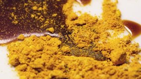 Pouring molasses on mixture of ginger and turmeric powders in 5x slow motion. This mixture is a great  support for the immune system. 