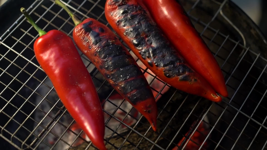 Red peppers are getting ready on the grill for a delicious barbecue party! Royalty-Free Stock Footage #1068850775