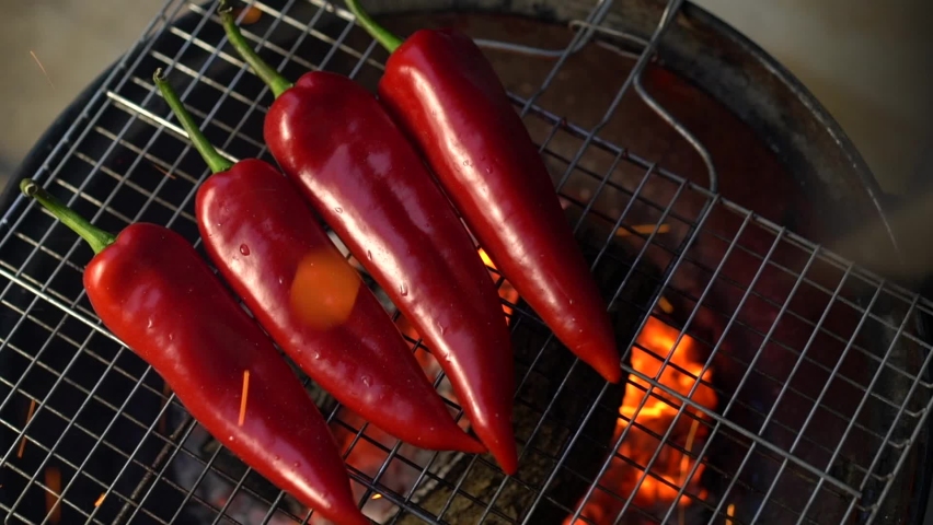 Red peppers are getting ready on the grill for a delicious barbecue party! Royalty-Free Stock Footage #1068850784