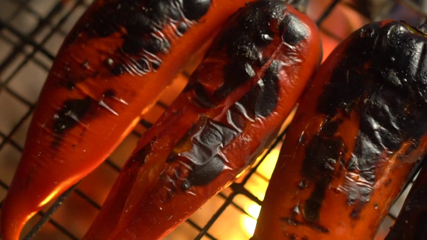 Red peppers are getting ready on the grill for a delicious barbecue party! Royalty-Free Stock Footage #1068850808