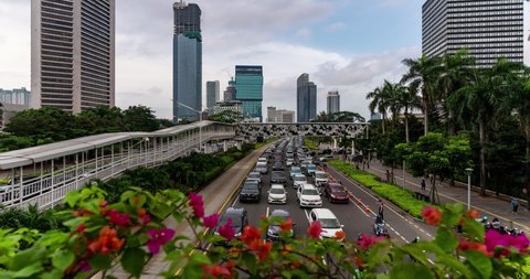 Traffic time lapse along the very crowded main avenue in Jakarta modern business district in Indonesia capital city. Jakarta is famous for one of the most congested city in the world