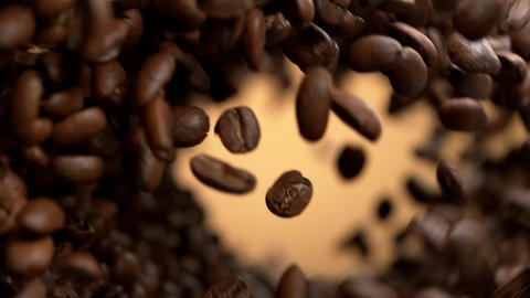 Super slow motion of flying coffee beans, rotating. Filmed on high speed cinema camera, 1000 fps.
