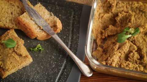 homemade meat pate with bread on a wooden table