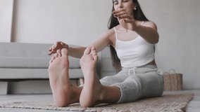 Young Woman doing balance exercise and Stretching sports Yoga, Black Sportswear Leggings and Top, bright room At home in the Morning. Video content. Vlog maker.