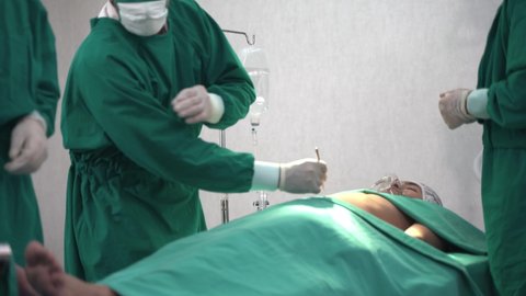 Professional Surgeons and Assistant operating a surgery case of human chest body in the operating room at Hospital. Concept doctor and nurse work in risky intensive care.
