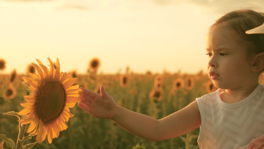 Little daughter in arms of farmer