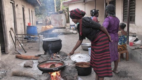 24th December 2020,Abuja Nigeria: Happy African woman prepares a traditional dish