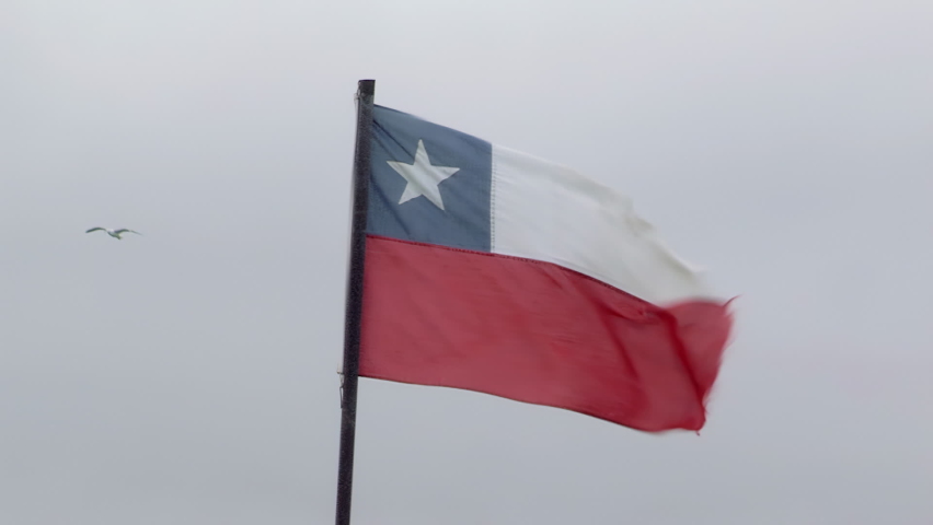 Flag of Chile over Windy Overcast Sky in Valparaiso, Chile, South America.  - Powered by Shutterstock - Get 15% off with code: PIKWIZARD15