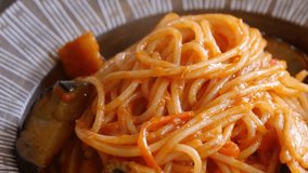 A close-up video topped with Neapolitan grated cheese made from tomato ketchup.