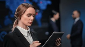 Confident businesswoman use tablet pc at modern holographic finance profit diagram office. Female boss surfing internet trade economic data with digital display technology. 4k Dragon RED camera - Powered by Shutterstock - Get 15% off with code: PIKWIZARD15
