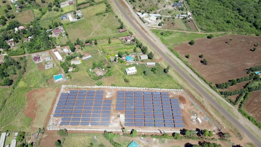 Drone view flying under the solar Panels in Loitokitok Kenya small village of Africa. Sustainable energy. Alternative energy source. Environmental conservation. Paris Agreement. Royalty-Free Stock Footage #1068891107