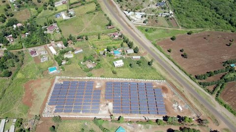 Drone view flying under the solar Panels in Loitokitok Kenya small village of Africa. Sustainable energy. Alternative energy source. Environmental conservation. Paris Agreement.