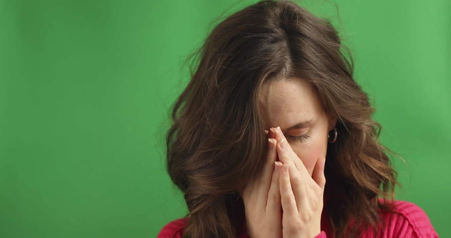 Sick frustrated sad young woman in pain cope with headache, eye strain emotional mental stress feel anxiety pressure panic attack touching nose bridge, face close up view, migraine concept. | Shutterstock HD Video #1068897245