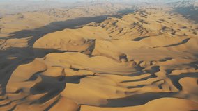 aerial video of the golden desert in sunset