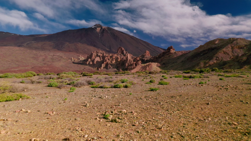 Teide National Park, a bird's eye view of the peak of the volcano. 
Ancient crater of Teide. Drone flight on the surface of the crater with takeoff to the summit of the highest point in Tenerie.
 Royalty-Free Stock Footage #1068914885