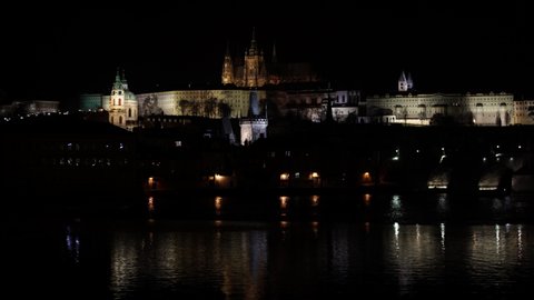  Prague Castle and St. Vitus Cathedral and Charles Bridge on the Vltava River in the center of Prague at night