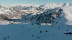 Mountains of the Alps in a sunny day in Europe. Drone  aerial video of snow peaks.