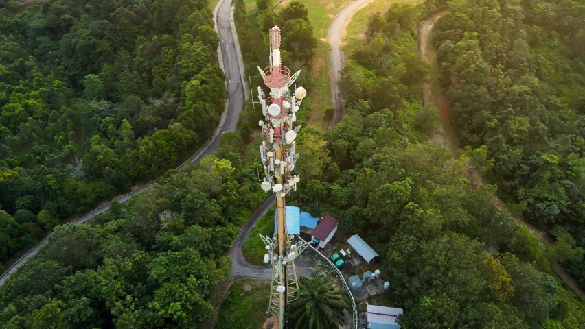 Rotating Ariel view footage at 5g communication tower. Technology concept.