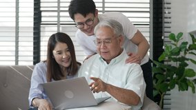 Asian senior. Modern family Asian old man using laptop with parents watching applications and enjoying laptop together with asian senior. Modern life family in house uncle and parents with laptops.
