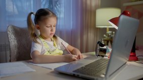 Schoolgirl Girl Studies Online On Laptop At Home.