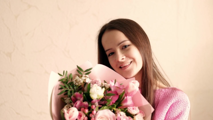 Congratulation happy birthday, anniversary, easter, bouquet of flowers in the hands of a girl