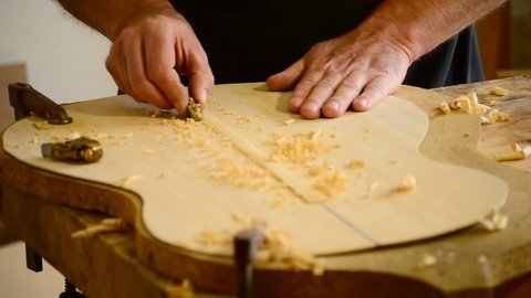 Luthier hands making a guitar