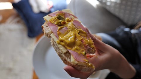 Homemade open sandwich on sourdough bread with ham, cheddar cheese and piccalilli