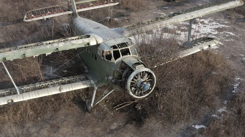 Broken abandoned transport plane An-2 - Colt - light transport aircraft, biplane. Remains of Ukrainian-made An-2 aircraft at an abandoned military airfield