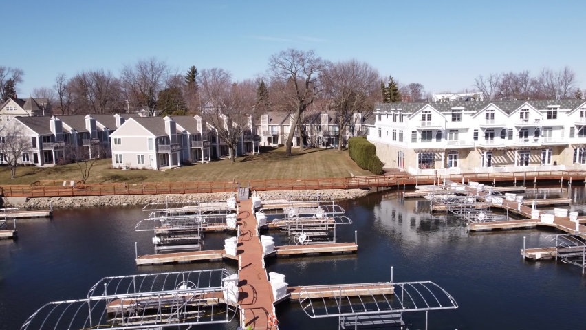 Aerial of boat docks dolly out to wide of frozen lake