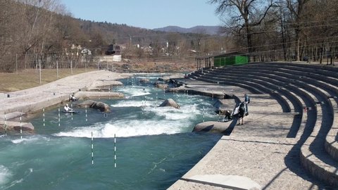 TACEN, SLOVENIA. 2.3.2020. Professional athletes training canoe slalom on white water rapids. Canoe slalom competition course on fast flowing river