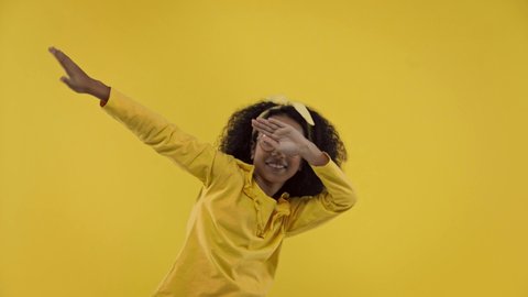 happy african american kid dancing isolated on yellow