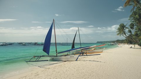 Philippines, Boracay Island, 2018.04.08: People rest at tropical white sand beach with sailboats aerial. Amazing seascape. Nature landscape with tourists. Water transport at ocean bay. Summer holiday