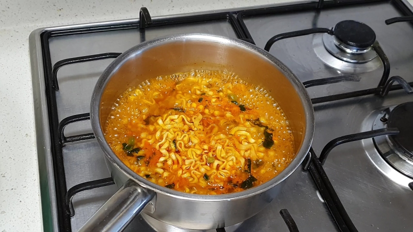 When the delicious instant noodle is cooked and the gas stove is turned off, water vapor is generated over the pot. Royalty-Free Stock Footage #1068961312