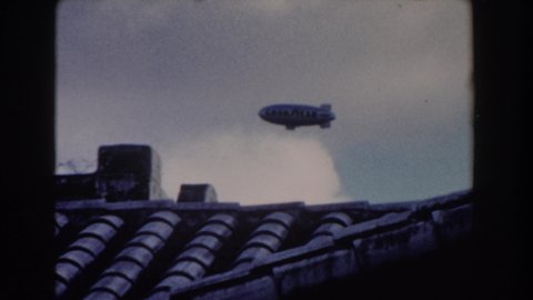 MIAMI FLORIDA-1960: A Zeppelin Flying On The Sky And A Bottom View Of A Helicopter Of Rescue Flying