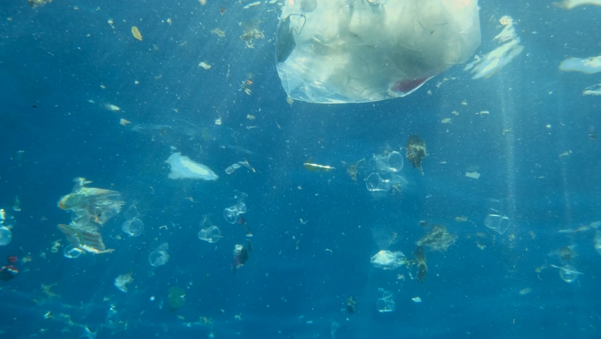 Slow motion, Massive plastics and other debris slowly drifts under surface of blue water in the sunlights. Plastic garbage environmental pollution problem of Ocean. Plastic garbage swims undeter Royalty-Free Stock Footage #1068970492