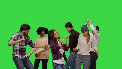 Young men and women dancing at the party on a Green Screen, Chroma Key.