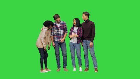 Young happy people chatting, telling funny things, joking, laughing, full size video on a Green Screen, Chroma Key.