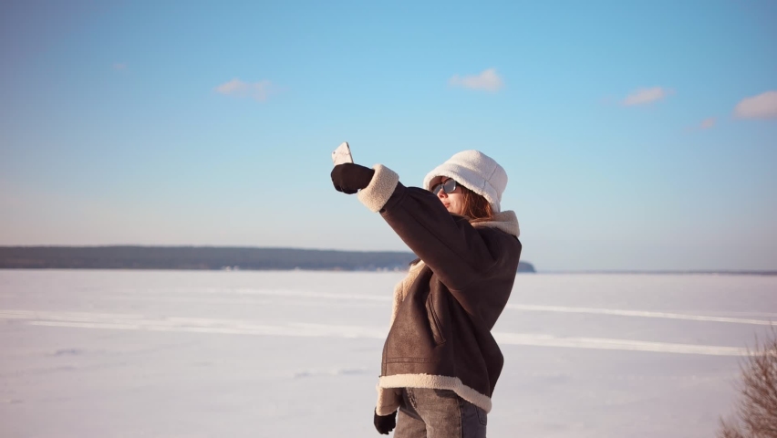 Happy couple takes a selfie while walking in winter weather. Outdoors