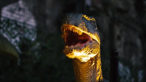 Close up of giant predator velociraptor dinosaurus with sharp teeth