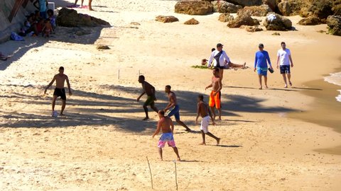 MORRO DE SAO PAULO, BRAZIL - circa OCTOBER 2019. Young men playing soccer at primeira praia beach in Bahia, Brazil.