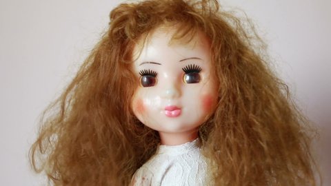 Old scary shaking doll with long red hair.