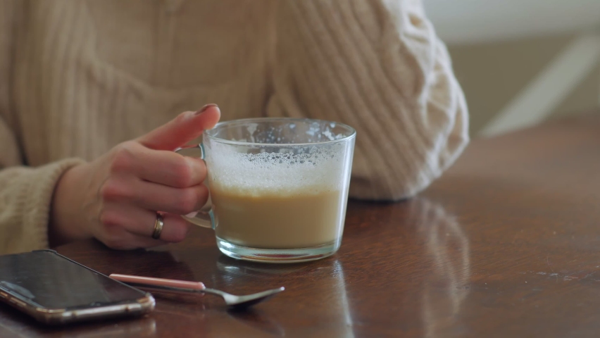 Unrecognizable woman drinking coffee closeup