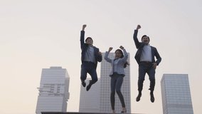 team of three asian business people celebrating success by jumping with modern city skyline in background - Powered by Shutterstock - Get 15% off with code: PIKWIZARD15