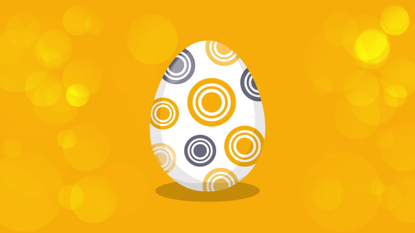 Happy Easter Greeting. Easter egg on a yellow bokeh background. Easter text coming out from the broken egg. 4K Video motion graphic animation. Royalty-Free Stock Footage #1069018180