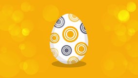 Happy Easter Greeting. Easter egg on a yellow bokeh background. Easter text coming out from the broken egg. 4K Video motion graphic animation.