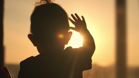 Sun Flare, Change the Future, Kid Dream, Kids Celebration, Holiday Bye, Up Hold, Night Party, Line Sunrise, Behind Sunshine, New Life. Anxious child knocks his hand on the window during sunset