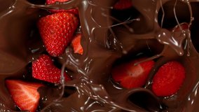 Super Slow Motion Shot of Fresh Cutted Strawberries Falling into Melted Chocolate at 1000 fps. - Powered by Shutterstock - Get 15% off with code: PIKWIZARD15
