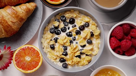 Healthy breakfast concept with corn flakes and fresh berries on white table