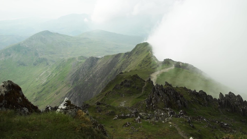 Clouds swirl against Snowdon jagged mountain tops timelapse